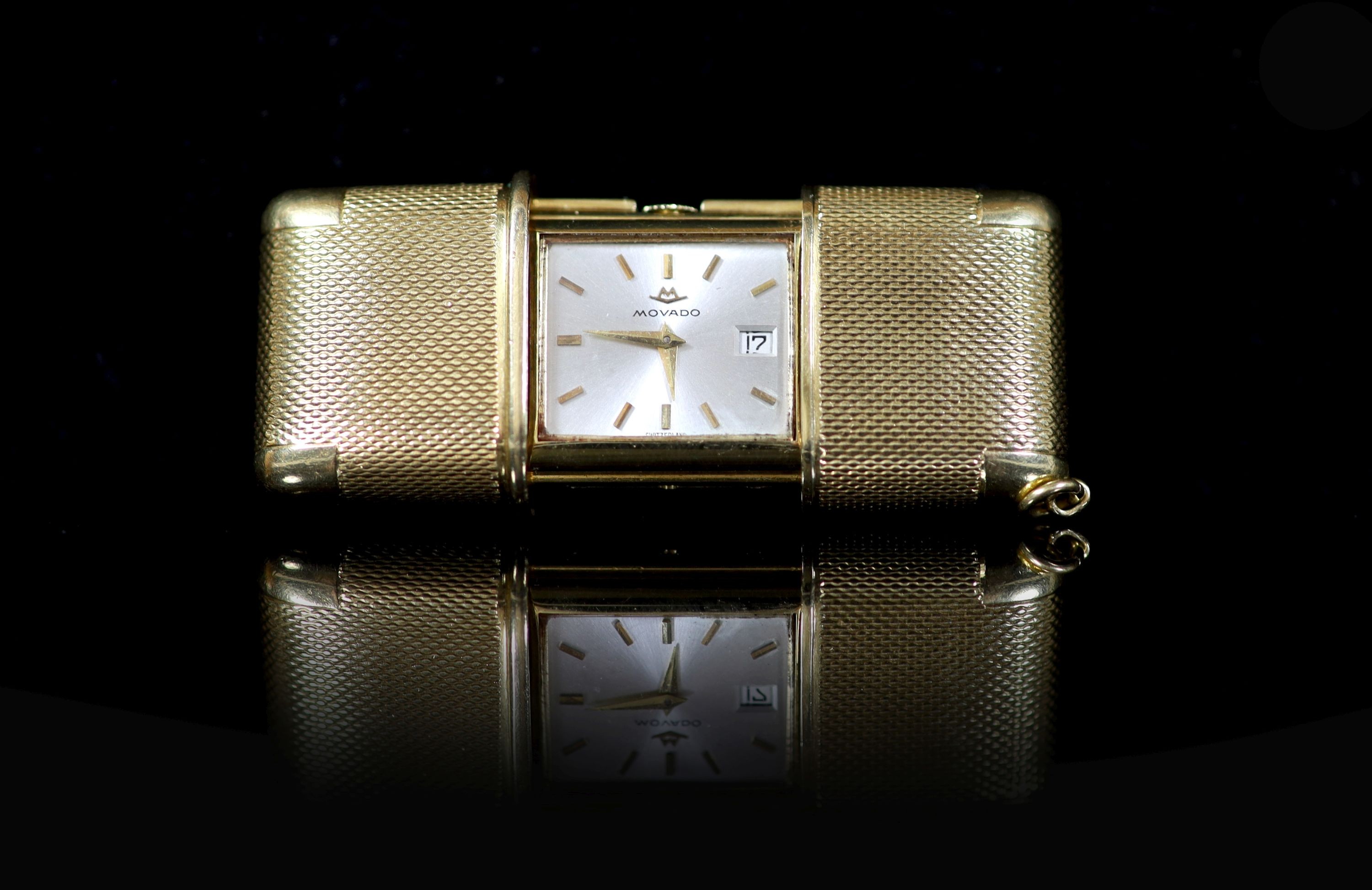 An engine turned 18ct gold cased Movado travelling watch